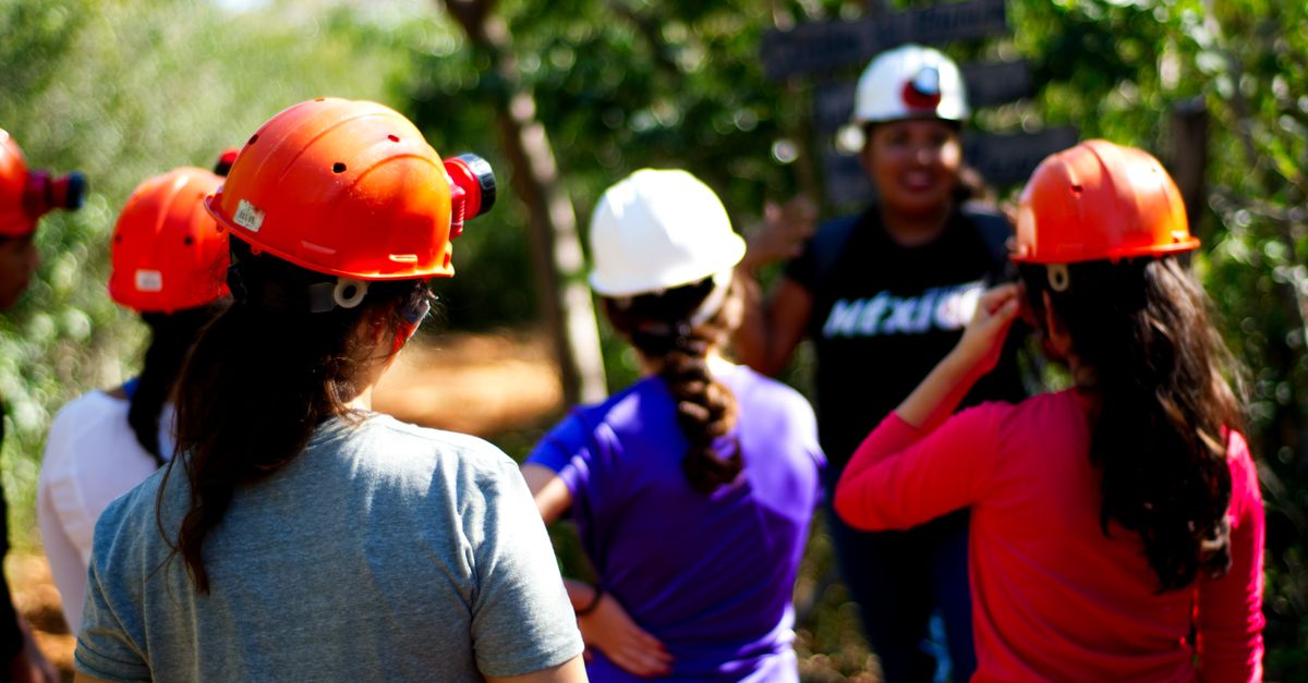Group of adults wearing helmets on a guided tour in Calcehtok, Yucatán, México.